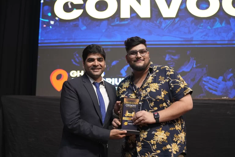 A guest and a graduate holding a trophy at a SkillCircle convocation